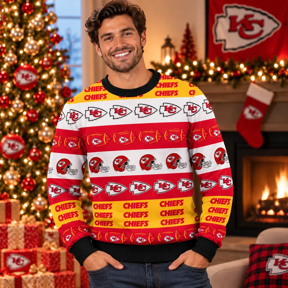 Man in a red, white, and gold striped Kansas City Chiefs ugly Christmas sweater with logos, footballs, and helmets